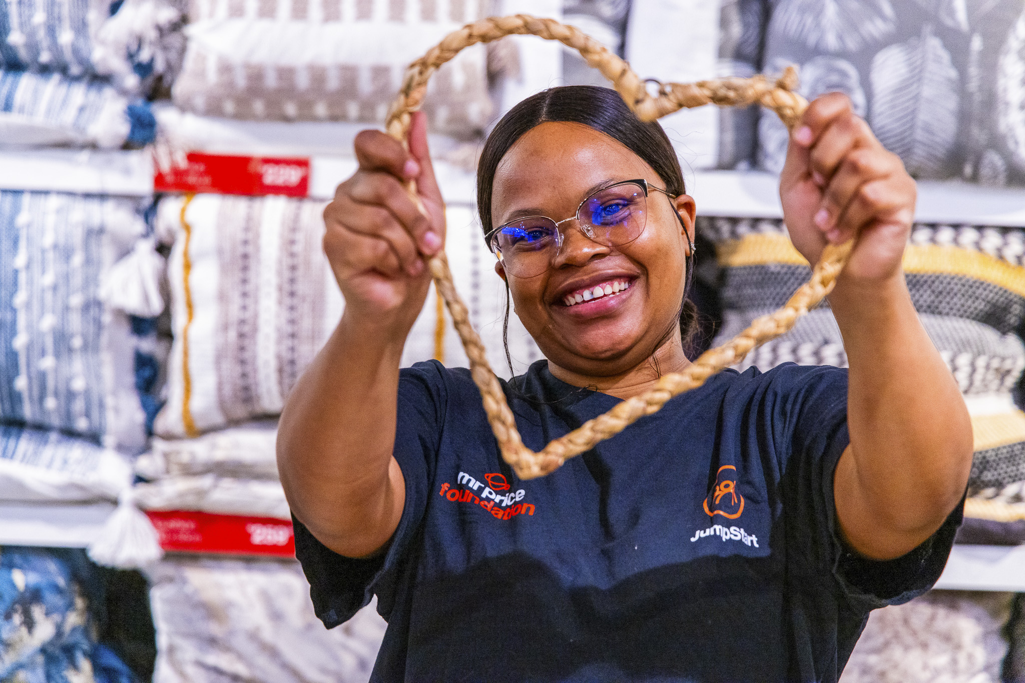 Woman from Mr Price Foundation holding up a heart